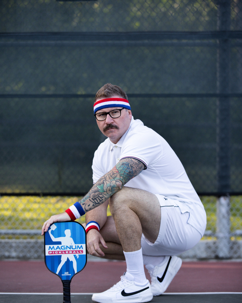 Tony Roberts on the Nawalli court — retro headband, Magnum paddle, ready position.