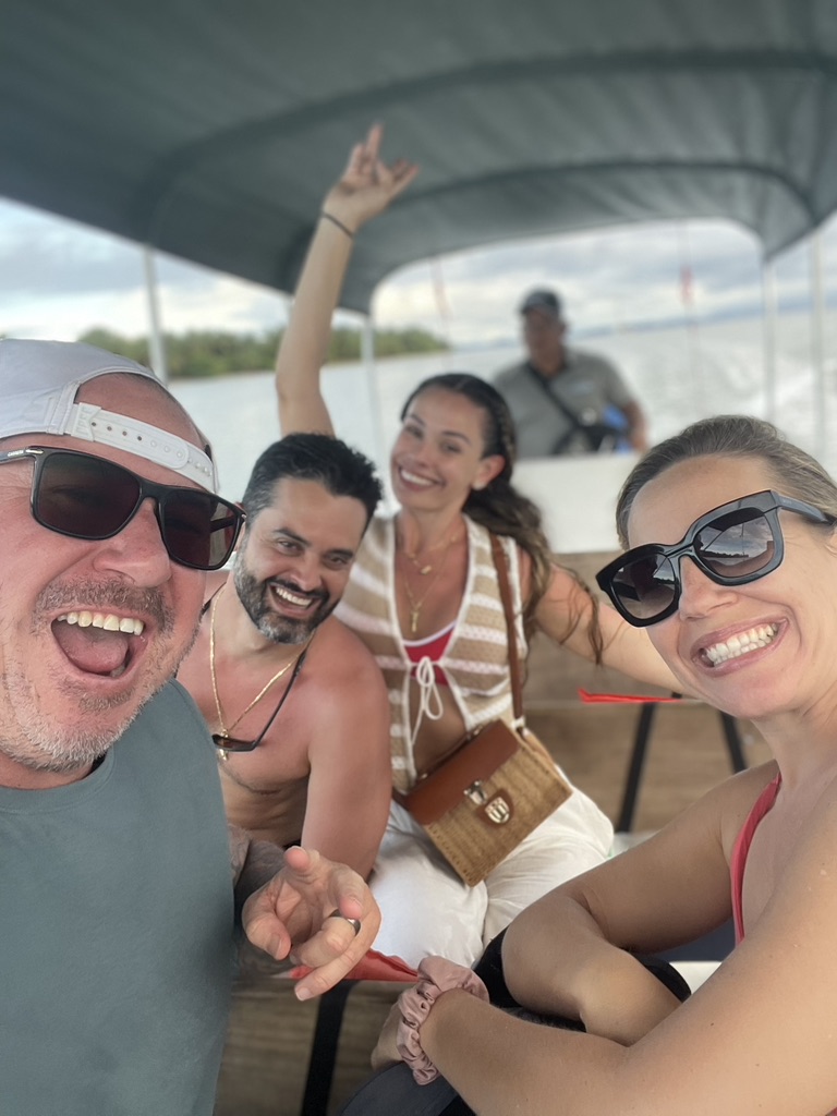 Four friends laughing on a boat