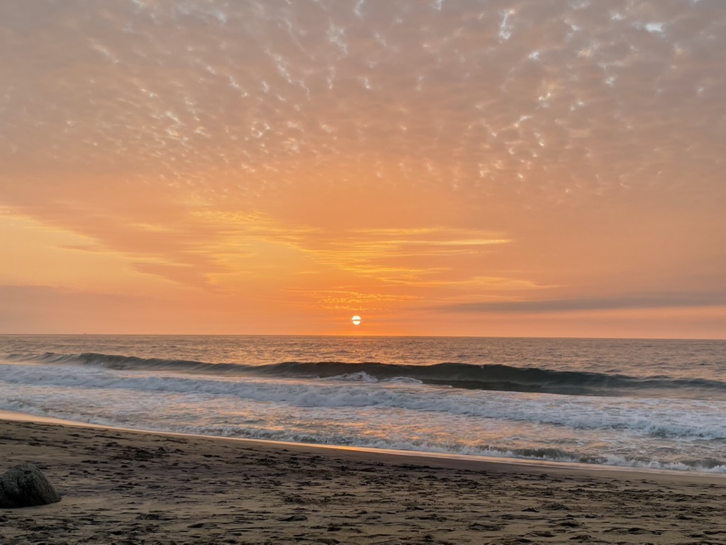 Ocean sunset over breaking waves